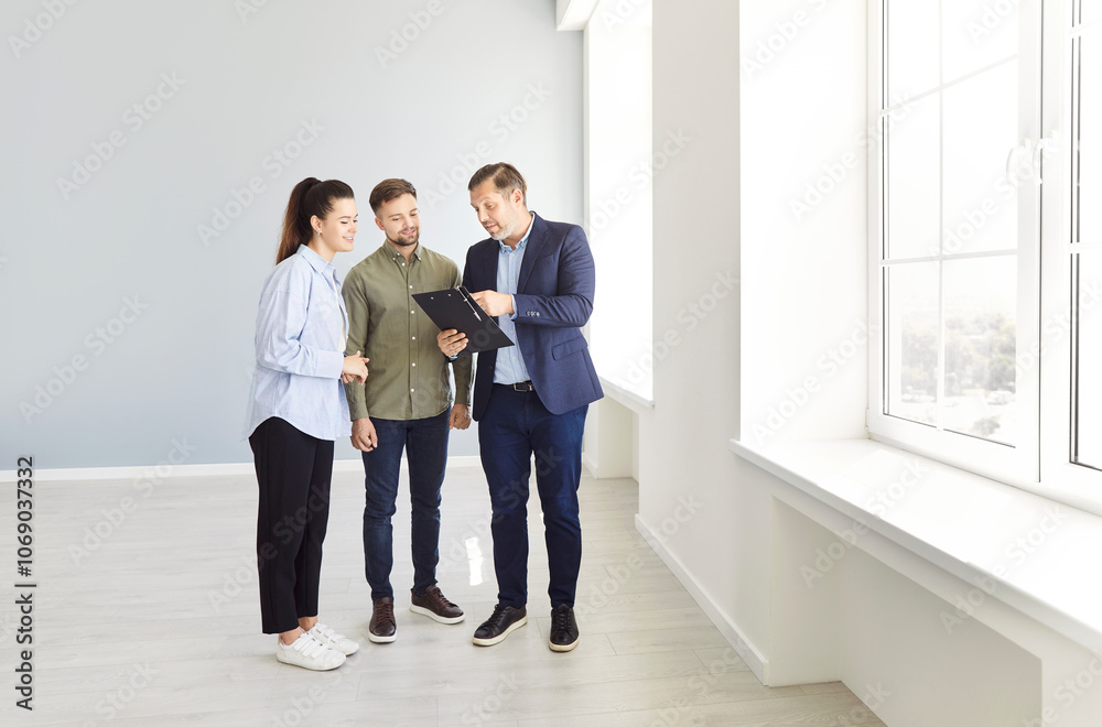 Fototapeta premium Realtor, real estate agent showing offering young couple family property, buying and selling service, helping consultation about mortgage, insurance, rent, tenancy agreement, building contract