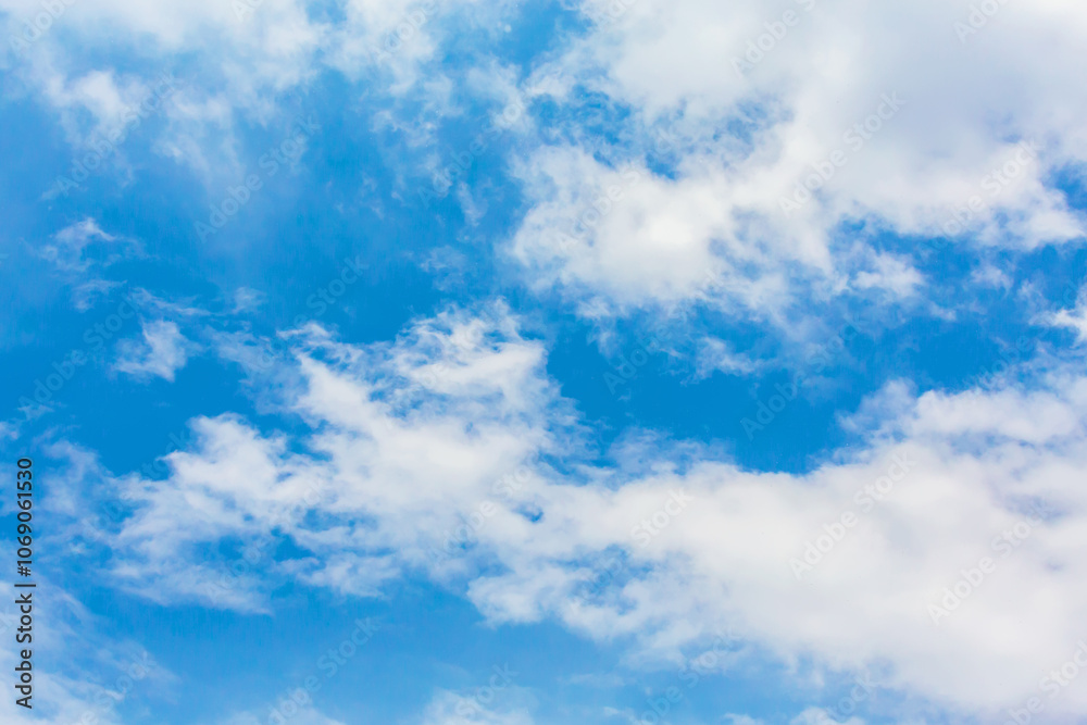 Serene blue sky with scattered white clouds for nature background or atmospheric wallpaper Serene blue sky with scattered white clouds for nature background or atmospheric wallpaper