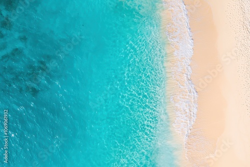 Turquoise sea gently kissing golden sandy beach: aerial view