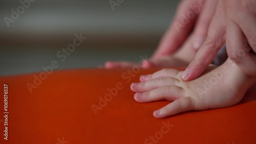 Wallpaper Mural Close-up of a pediatrician guiding a child's hands in coordinated movements to support crawling development. Concept of early physical exercise, motor skills, and developmental support. Torontodigital.ca