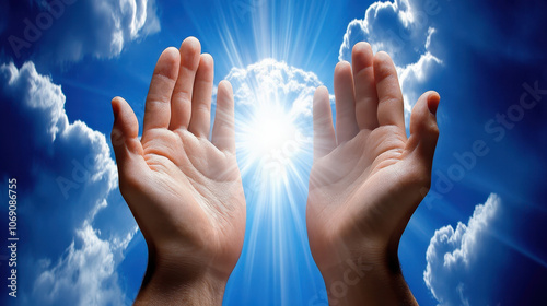 Two hands reaching for bright light in cloudy sky symbolizing hope and faith photo