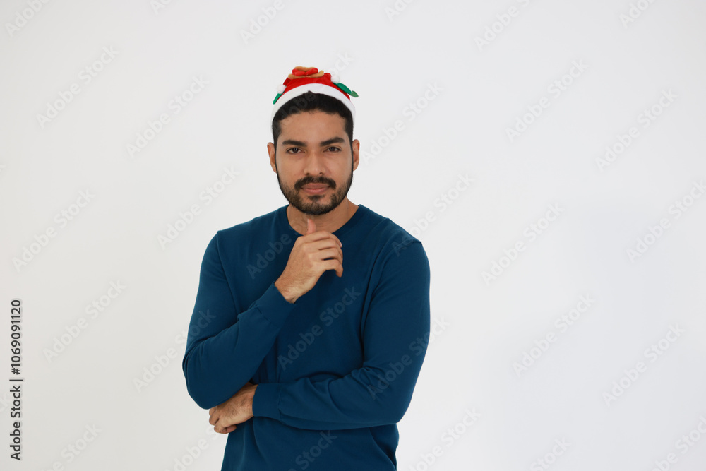 A smiling smart man wearing a Santa hat celebrating Christmas against a white background A smiling smart man wearing a Santa hat celebrating Christmas against a white background
