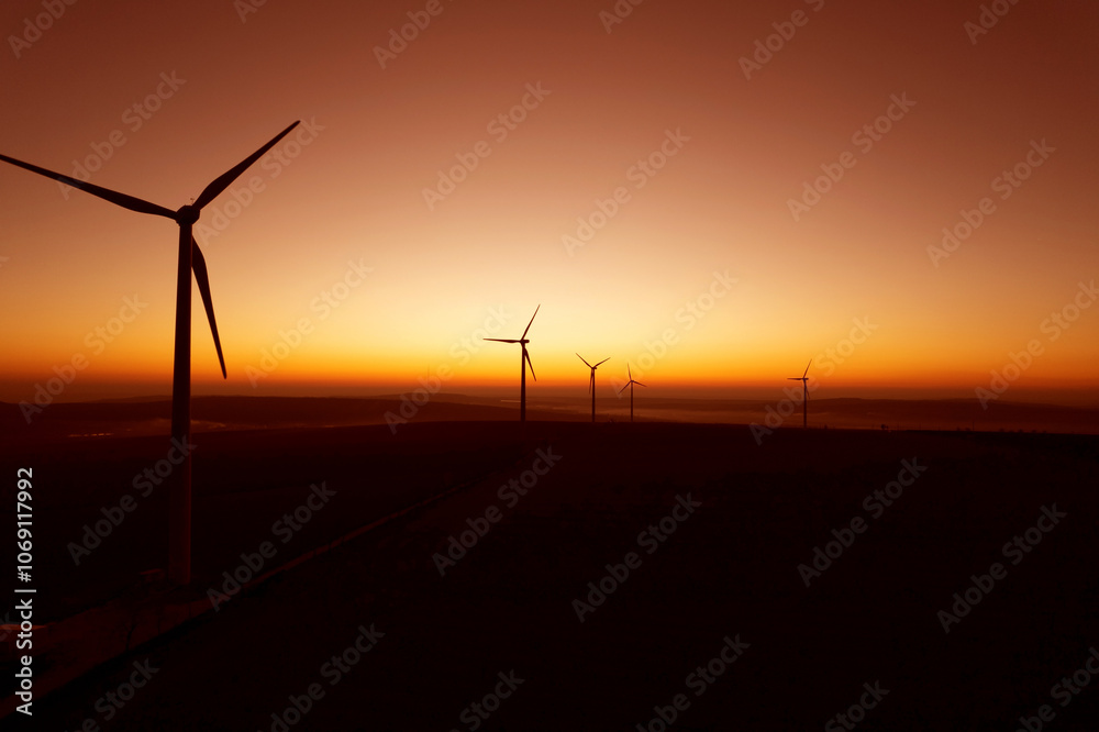 Obraz premium Windmill turbines generating green energy electric.Green energy helps reduce carbon emissions and makes earth cleaner and more ecological.