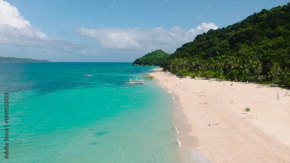 Inshore waves over the white sand in Puka Shell Beach. Boracay Island. Philippines.
