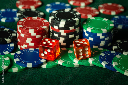 A popular and exciting dice game played on a green poker table in a casino. A winning combination of two fives brought in a lot of chips photo