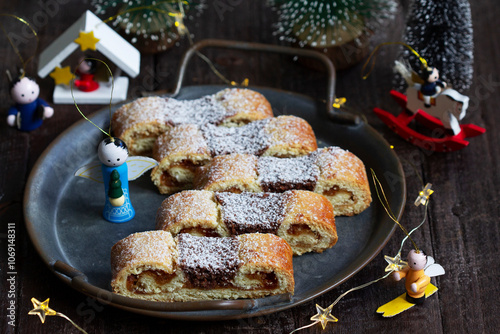 Obraz na płótnie Grandfather's mustache cookies made from shortcrust pastry filled with nuts, jam and cocoa, Christmas toys and garland. w salonie