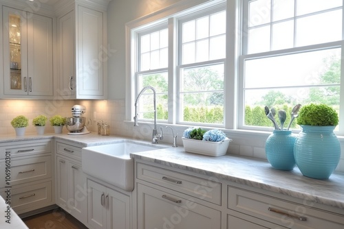 White Kitchen with Marble Countertops, Sink, and Windows