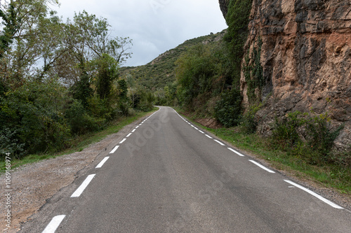 Road to the town of Sant Llorenç de Montgai between rocks and the Segre river, Lleida.