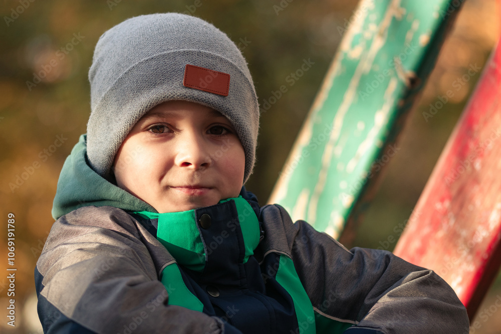 Smiling little boy on playground in autumn Smiling little boy on playground in autumn