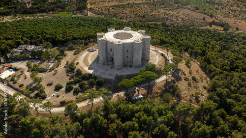 Aerial view of Castel del Monte. It is a castle situated on a hill near Andria in the Apulia region, Italy. A medieval fortress famous for its bold octagonal plan. There is a dense forest around it.