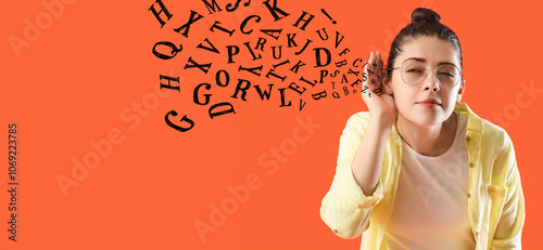 Young gossip woman trying to hear something on orange background, closeup