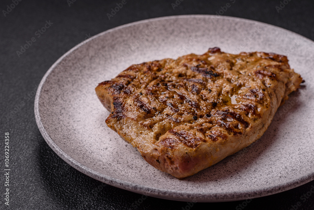 Grilled beef or pork steak with salt, spices and herbs Grilled beef or pork steak with salt, spices and herbs