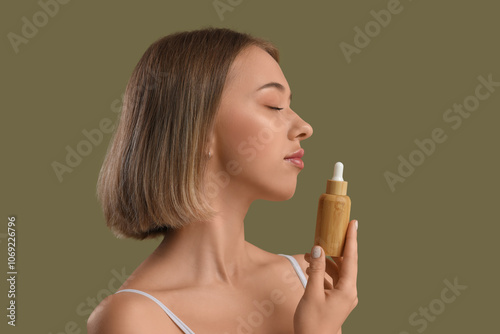 Young woman with bottle of ...