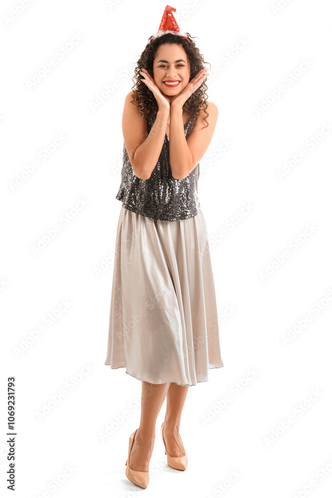 Beautiful African-American woman in Santa hat on white background. New Year celebration Beautiful African-American woman in Santa hat on white background. New Year celebration