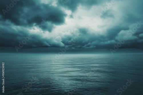 A vast ocean stretches beneath a tumultuous sky, full of swirling clouds and capturing nature's raw power.