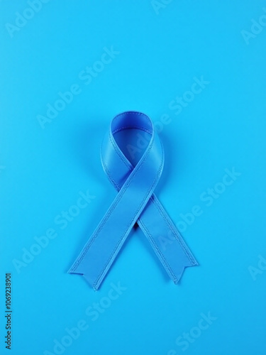 Blue ribbon on blue background for world diabetes day or prostate cancer awareness month photo