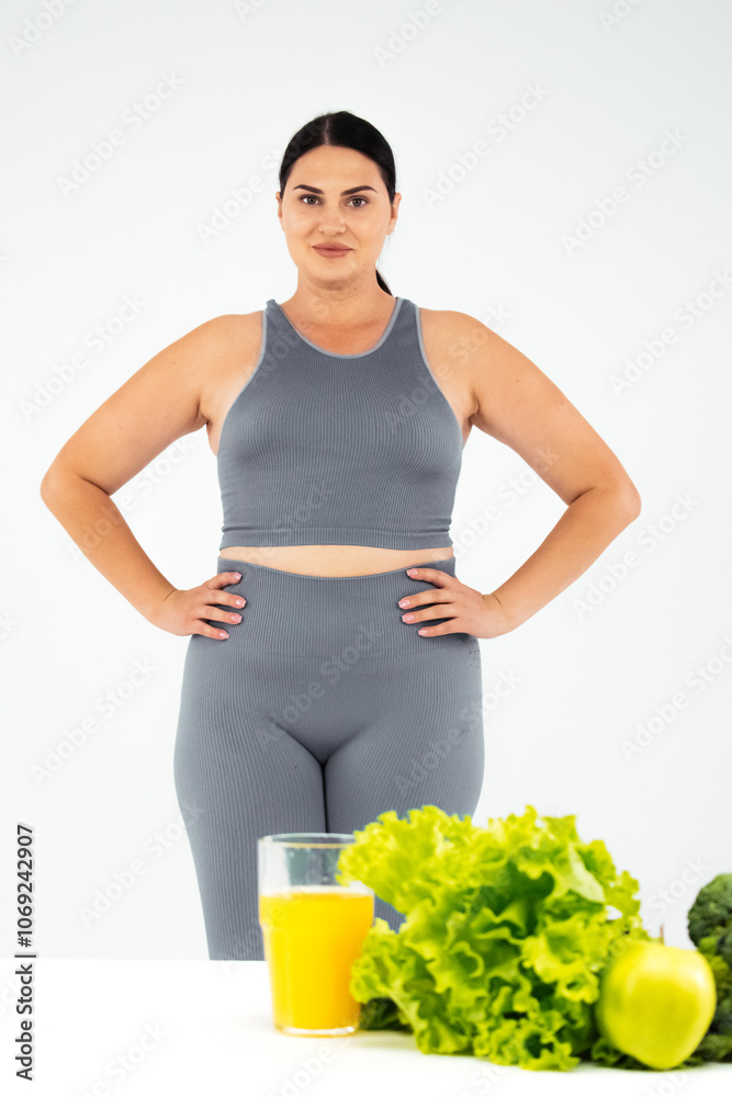 Close-up of a fresh apple, lettuce leaves, and a glass of orange juice. A concept of healthy eating, active lifestyle, and vegetarianism.