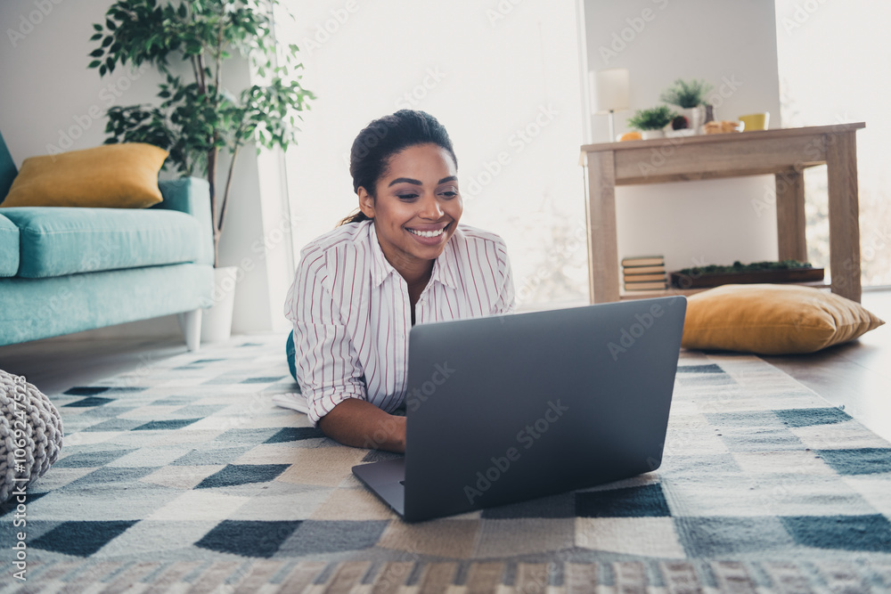 Photo of pretty young girl lying floor use laptop wear shirt modern interior apartment indoors