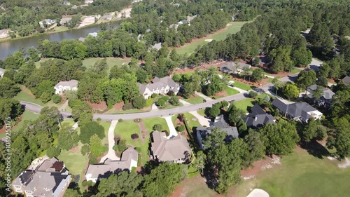 Suburban neighborhood captured by drone in California, USA, showing green lawns, residential houses, and tree-filled surroundings, highlighting a peaceful, scenic community landscape.