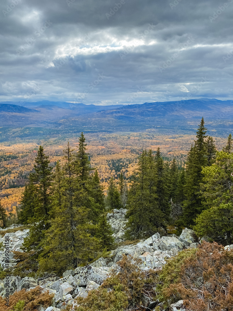 This stunning mountain landscape features lush trees and rocky formations in the foreground, with majestic mountains rising in the background, creating a captivating view This stunning mountain landscape features lush trees and rocky formations in the foreground, with majestic mountains rising in the background, creating a captivating view