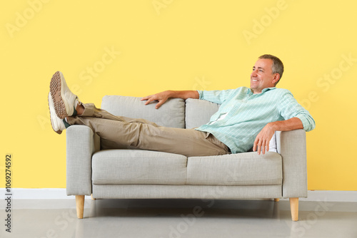 Old man lying on sofa near ...