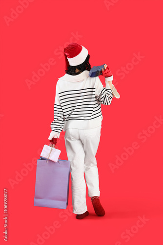 Young woman in Santa hat wi...