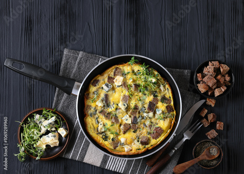 omelette with blue cheese, rye croutons and thyme photo