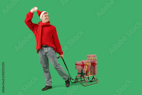 Young man carrying sledge w...