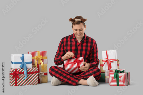 Young man in pajamas with C...