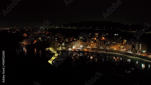 Beautiful night cityscape aerial view on the island of Malta. City lights at night, urban landscape on the embankment road and traffic on the roads. High quality 4k footage photo