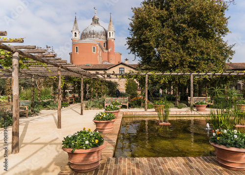 Detail of a garden and detail of the church of Redentore in Venice, Italy
