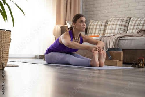 Young woman practicing yoga at home