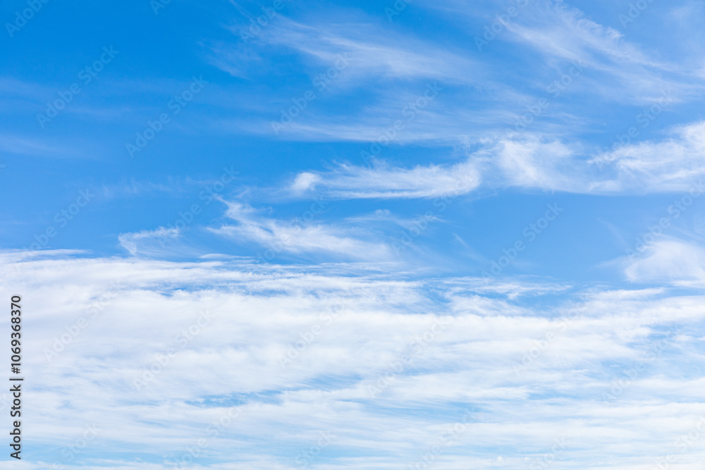 Blue sky with fluffy white cirrus clouds. The sky is clear and bright, and the clouds are scattered throughout the sky. Scene is peaceful and serene, copy space. High quality photo Blue sky with fluffy white cirrus clouds. The sky is clear and bright, and the clouds are scattered throughout the sky. Scene is peaceful and serene, copy space. High quality photo