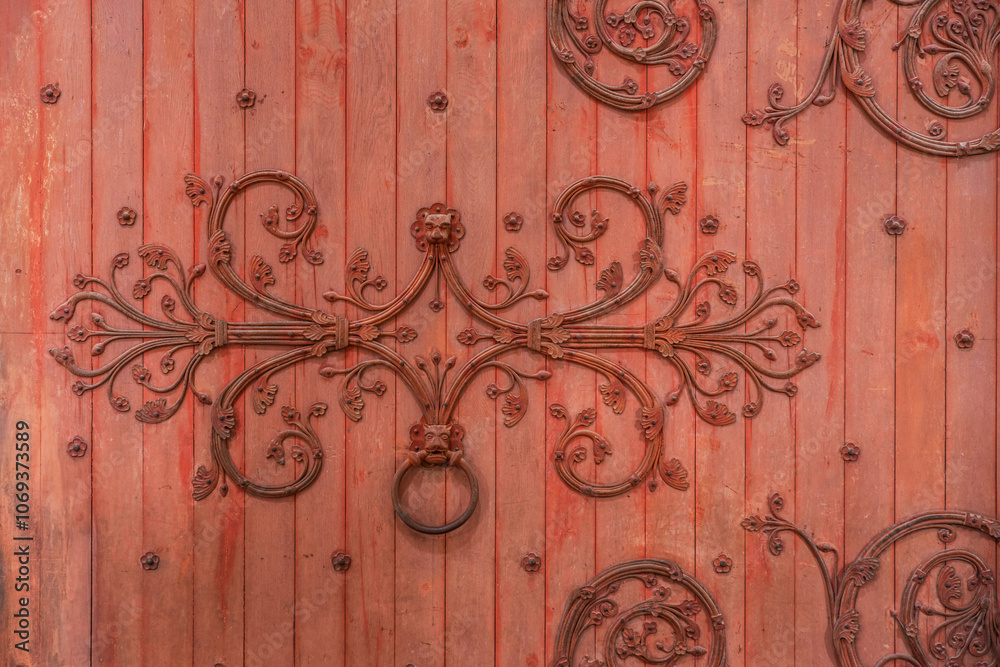 Detail of the red wooden entrance door to the basilica of Vézelay in Burgundy, France