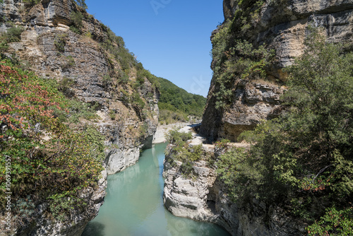 Osumi Gorge, Albania - August 15 2024: Stunning view of Osumi Canyon (Albanian: Kanioni i Osumit), showcasing the breathtaking cliffs, vibrant greenery, and winding river through dramatic landscape.