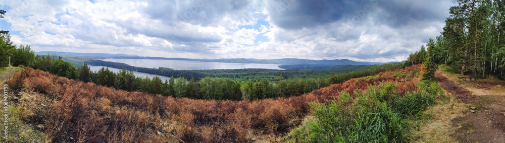 This stunning image showcases a breathtaking panoramic view of a lush green forest, with a beautiful lake visible in the distance, surrounded by natures splendid offerings This stunning image showcases a breathtaking panoramic view of a lush green forest, with a beautiful lake visible in the distance, surrounded by natures splendid offerings