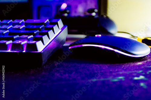 computer rgb wireless  mouse and keyboard on a table on a dark black background
