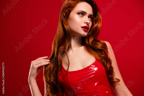 Photo of attractive lady look empty space touch shoulder dressed sexy leather garment isolated on red color background