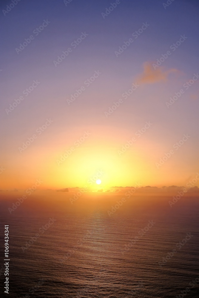 Maderia - A tranquil sunset over the ocean, with the sun gradually disappearing below the horizon, casting warm golden hues across the sky and reflecting on the calm water. Maderia - A tranquil sunset over the ocean, with the sun gradually disappearing below the horizon, casting warm golden hues across the sky and reflecting on the calm water.