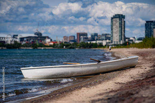Canvas Print White boat at Hanlan's Nudist Beach in the Toronto Islands.