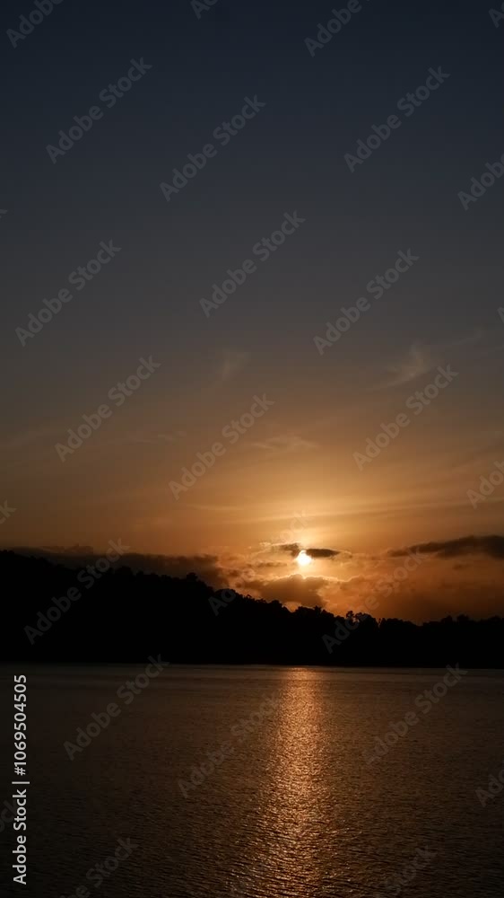 Sunrise view through the grass in Batulicin, South Kalimantan, capturing the serene and golden morning light in a tranquil natural setting Sunrise view through the grass in Batulicin, South Kalimantan, capturing the serene and golden morning light in a tranquil natural setting