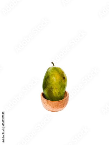 Green Mango on a wooden bowl