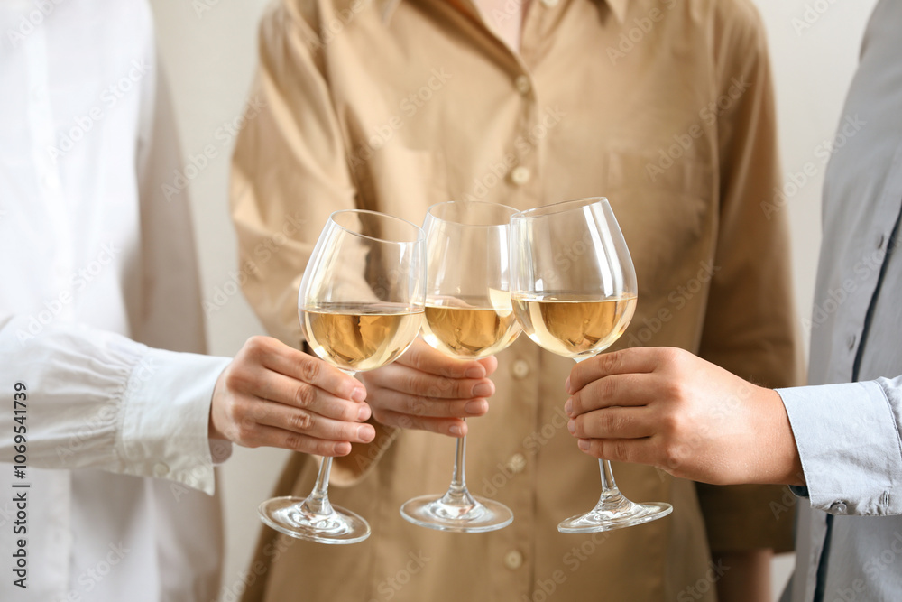 People clinking glasses of wine indoors, closeup People clinking glasses of wine indoors, closeup