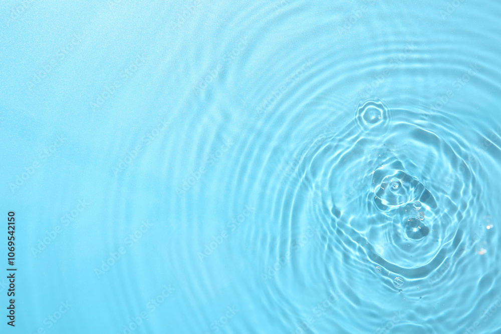 Rippled surface of clear water on light blue background, top view Rippled surface of clear water on light blue background, top view