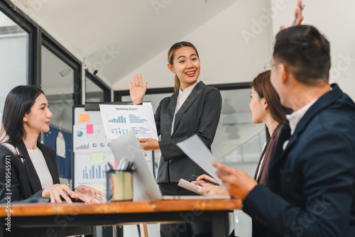 businesswoman presents marketing report to colleagues in modern office. team engages in discussion, showcasing collaboration and professionalism