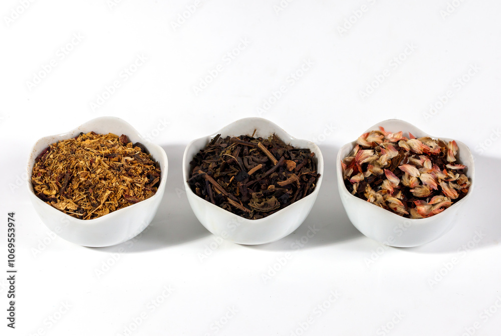 Assortment of dry herbal and berry tea in the little bowl isolated on a white background. Tea party concept. medicinal herbs. Assortment of dry herbal and berry tea in the little bowl isolated on a white background. Tea party concept. medicinal herbs.
