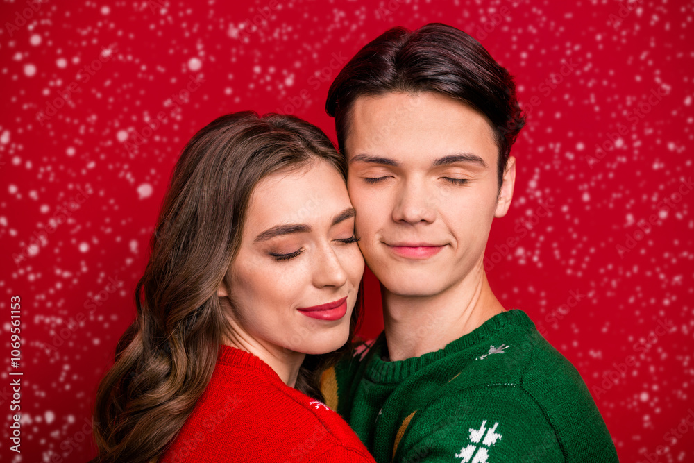Photo of dreamy adorable husband wife wear xmas sweaters embracing closed eyes isolated red color background