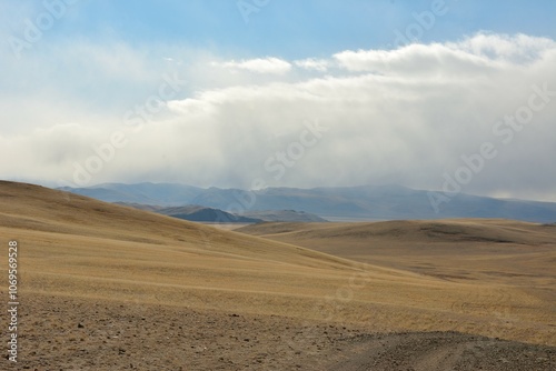 Photography High gentle hills of barrenness in the endless autumn steppe under a cloudy sky