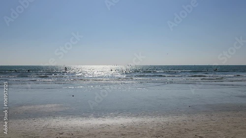Silhouette of a family walking in Yuigahama beach in Kamakura, Japan