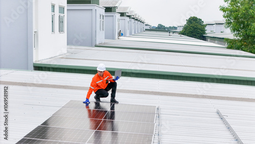Wallpaper Mural Aerial view of a rooftop with solar panels, showing a technician in safety gear performing maintenance. The scene highlights renewable energy, solar technology, and sustainable infrastructure. Torontodigital.ca